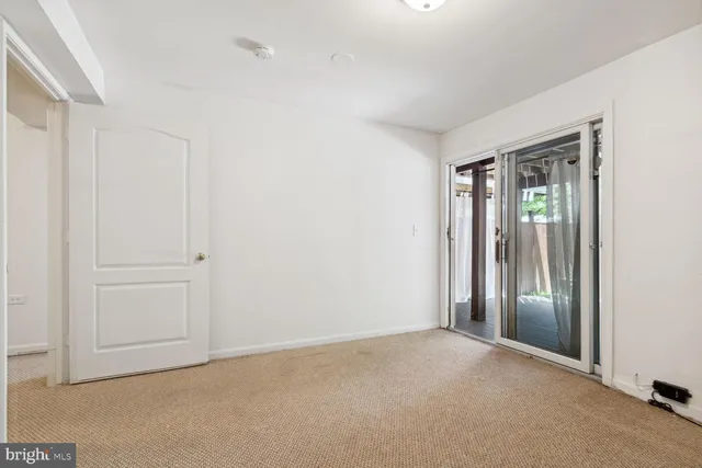 an empty room with windows and closet