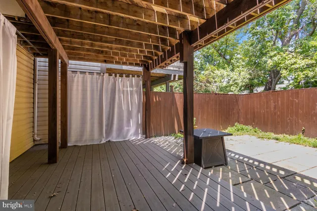 a view of backyard with deck and wooden floor