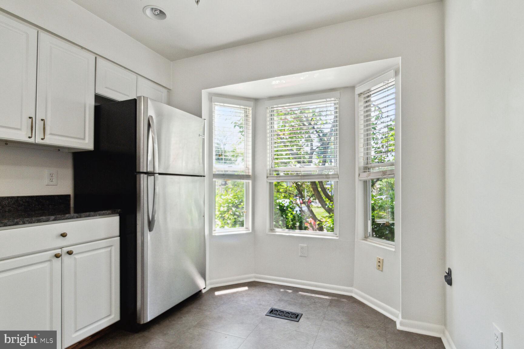 2849 Schoolhouse Circle Silver Spring, MD 20902 - Photo 5 of 31 a kitchen with a refrigerator a stove top oven and cabinets