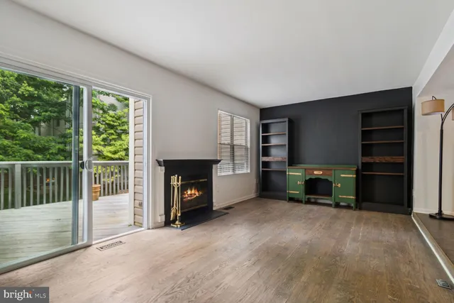 a view of a livingroom with a fireplace and window
