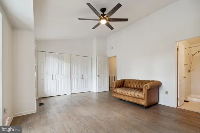a living room with furniture and a ceiling fan