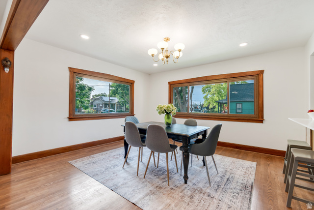 4883 South Center Street Murray, UT 84107 - Photo 4 of 32 Bright dining space featuring wood-finish flooring, extensive wood trim, and two large windows