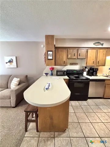 a kitchen with a sink a stove a table and chairs