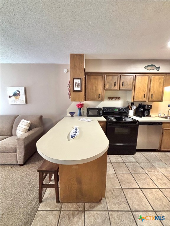 454 15th Street Port O'Connor, TX 77982 - Photo 15 of 45 a kitchen with a sink a stove a table and chairs