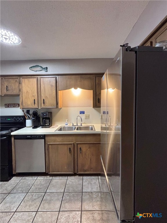 454 15th Street Port O'Connor, TX 77982 - Photo 19 of 45 a kitchen with granite countertop a refrigerator and a sink