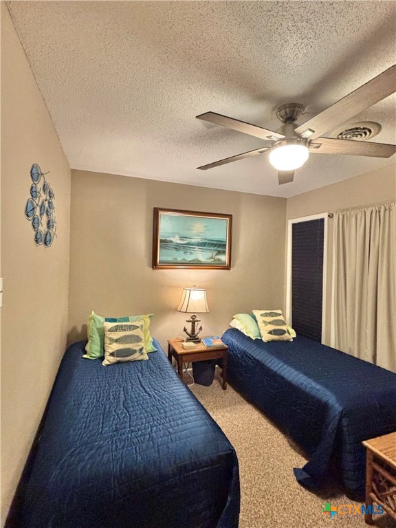 454 15th Street Port O'Connor, TX 77982 - Photo 25 of 45 a bedroom with a bed and a chandelier