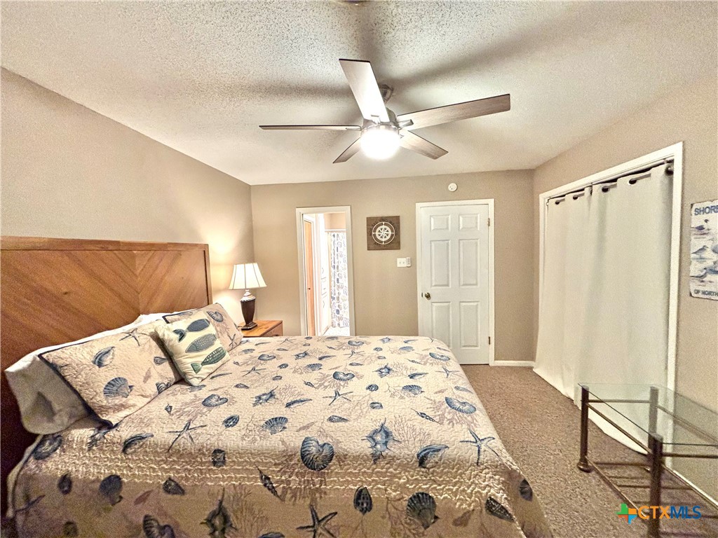 454 15th Street Port O'Connor, TX 77982 - Photo 31 of 45 a bedroom with a large bed and a chandelier