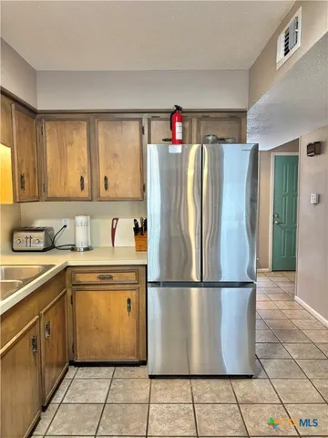 a white refrigerator freezer sitting inside of a kitchen