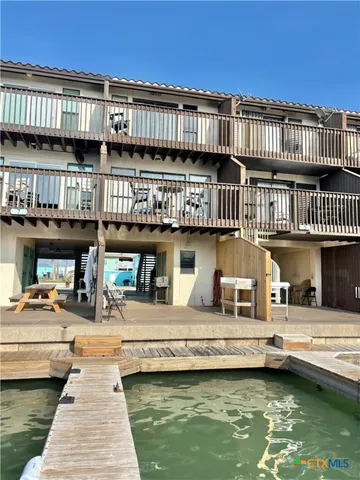a view of a balcony with wooden chairs