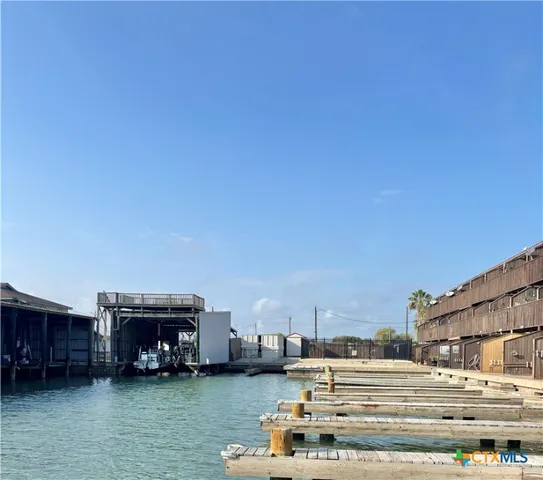 a view of a building with cars parked