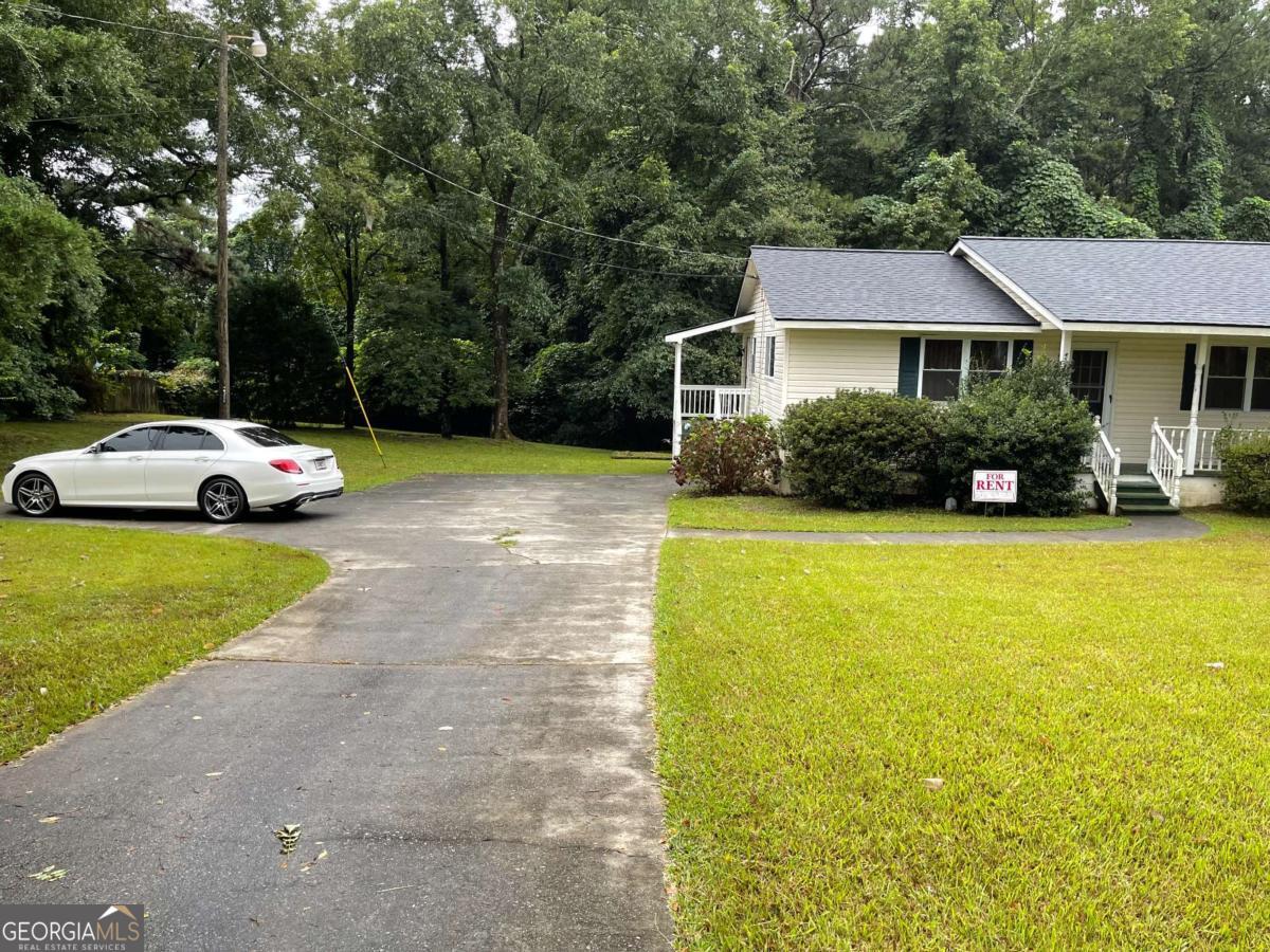 1031 Rock Springs Road Lawrenceville, GA 30043 - Photo 2 of 12 a front view of a house with garden