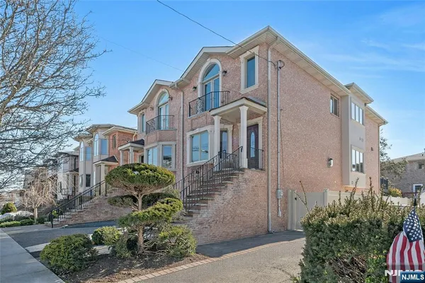 a front view of a house with a garden