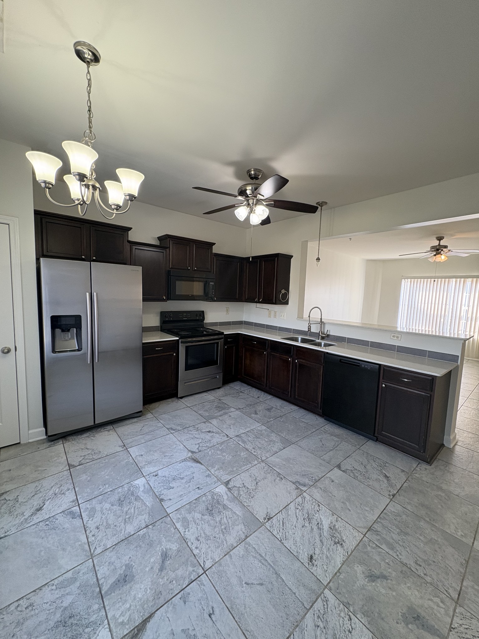 735 Tulip Grove Road, Unit 303 Hermitage, TN 37076 - Photo 2 of 16 a large kitchen with cabinets and stainless steel appliances