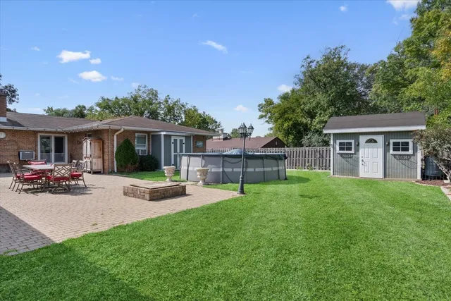 a view of a house with a yard and sitting area
