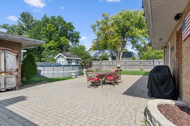 a front view of house with yard outdoor seating and barbeque oven