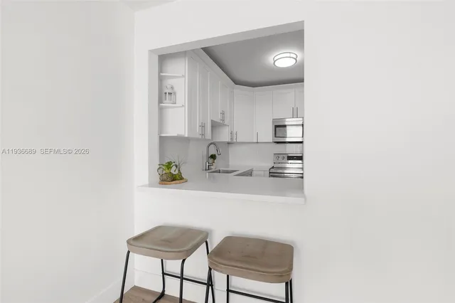 a kitchen with stainless steel appliances granite countertop a sink and a cabinets