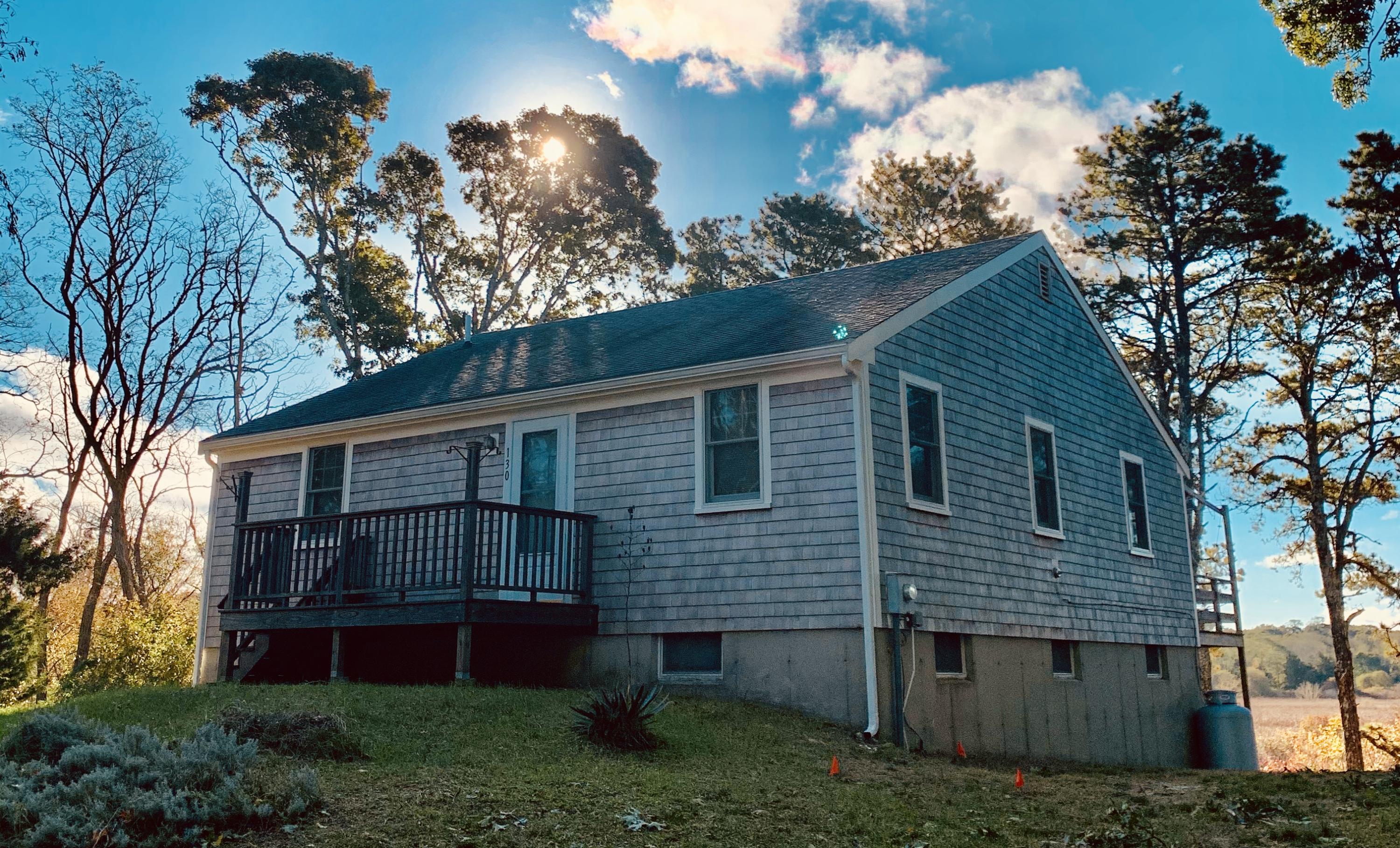 130 Peace Valley Road Wellfleet, MA 02667 - Photo 1 of 28 a view of backyard with plants and large tree