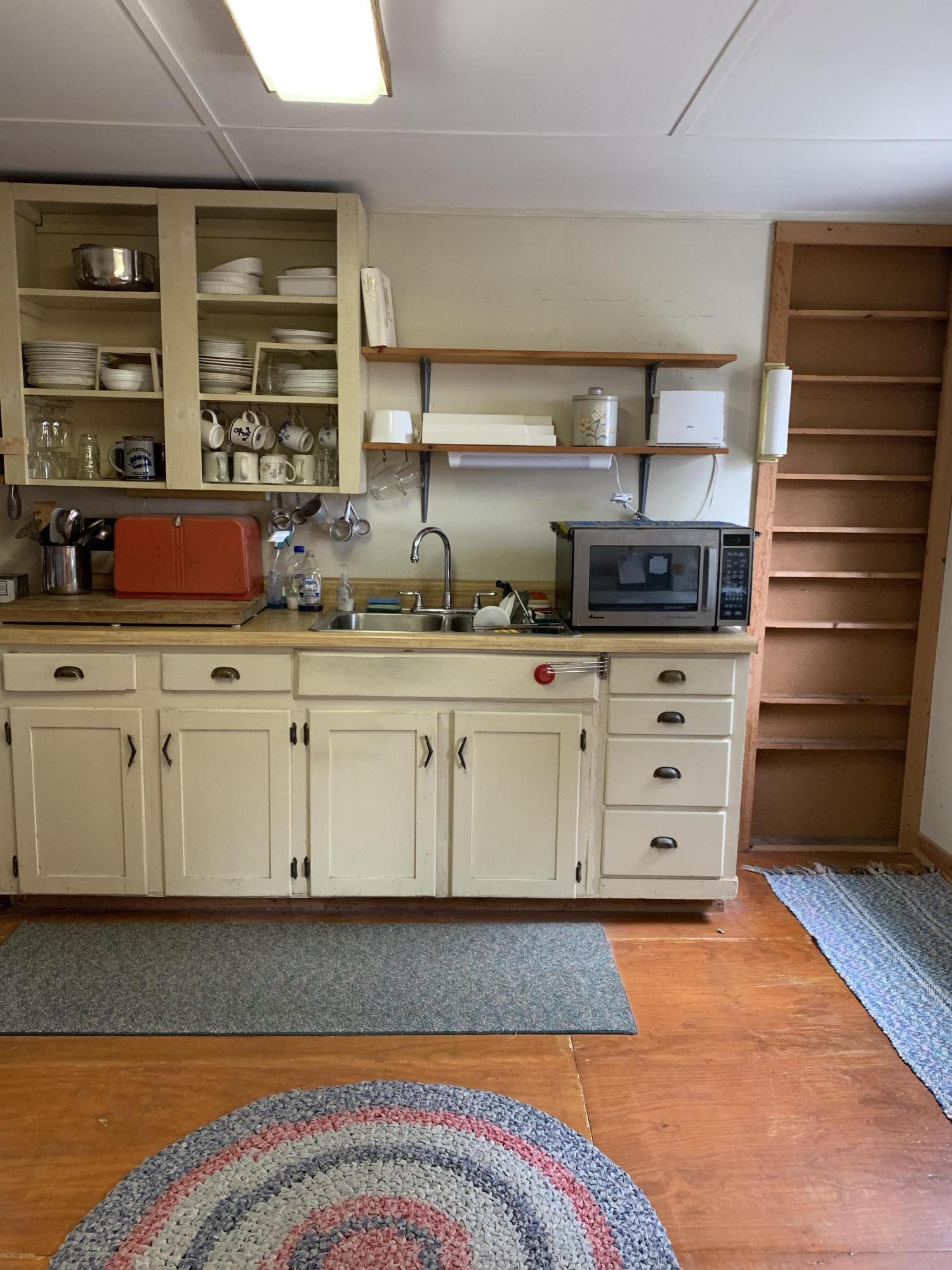 130 Peace Valley Road Wellfleet, MA 02667 - Photo 19 of 28 a kitchen with a sink and cabinets