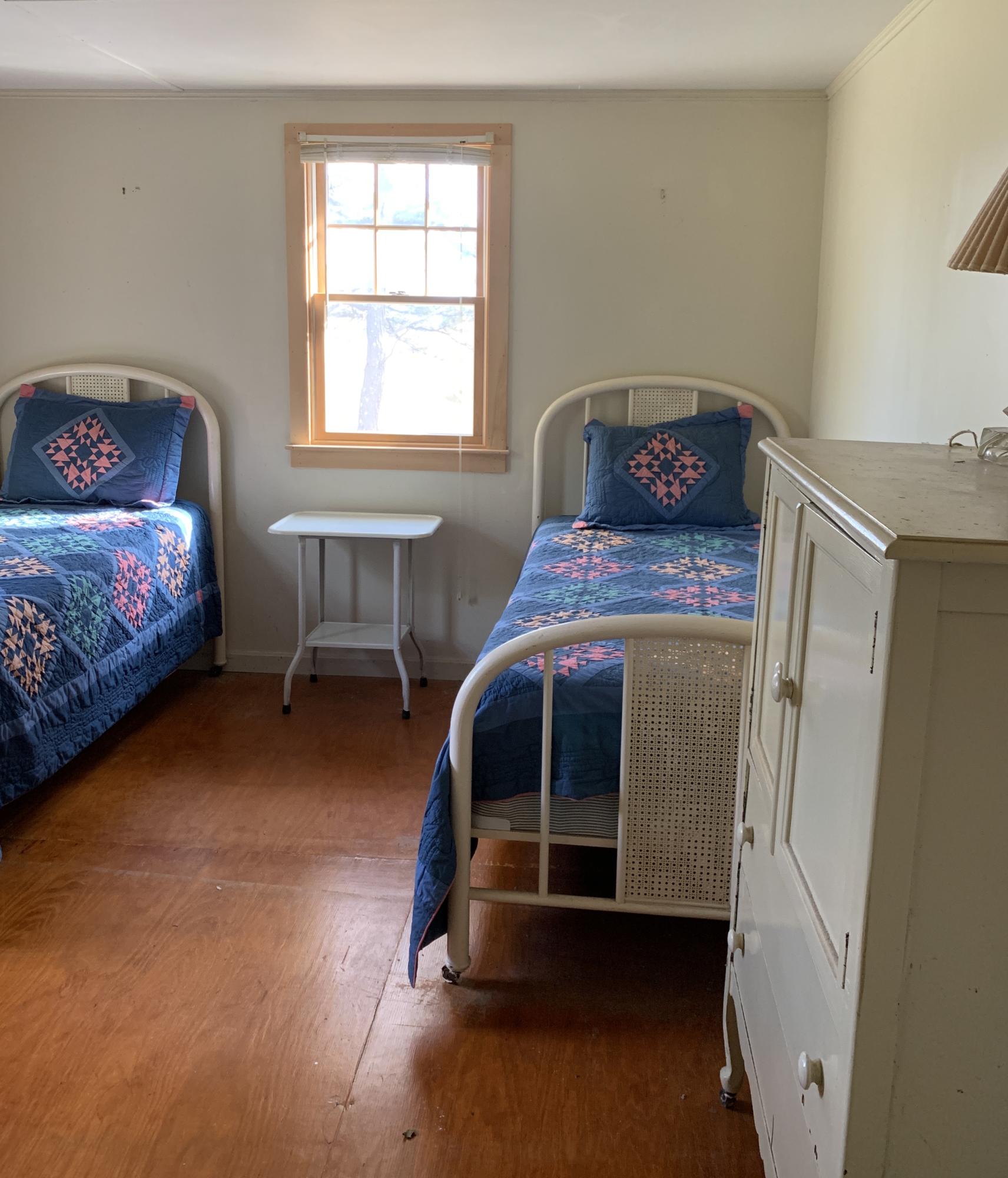 130 Peace Valley Road Wellfleet, MA 02667 - Photo 25 of 28 a bedroom with a bed and a window