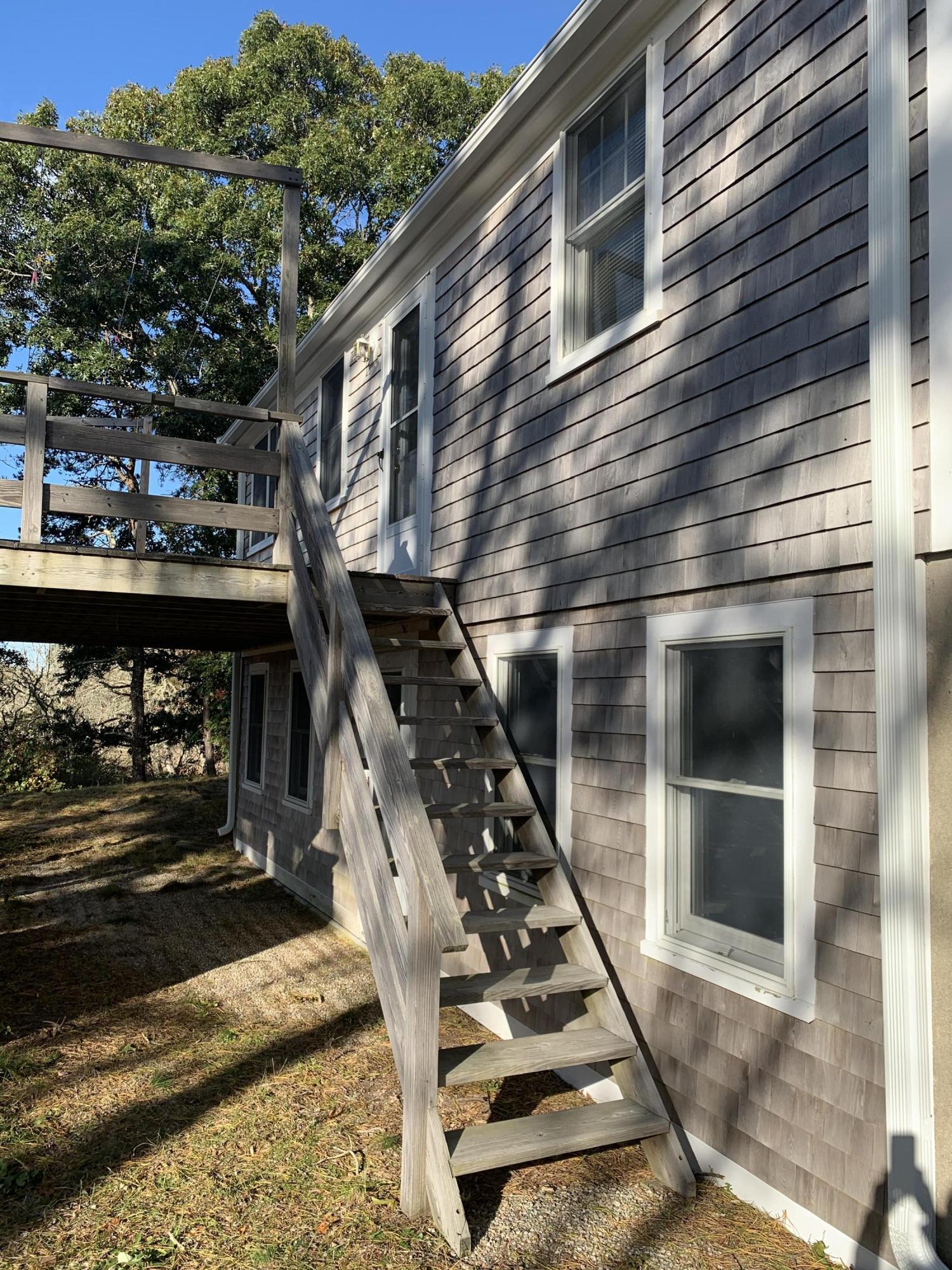 130 Peace Valley Road Wellfleet, MA 02667 - Photo 27 of 28 a backyard of a house with wooden stairs