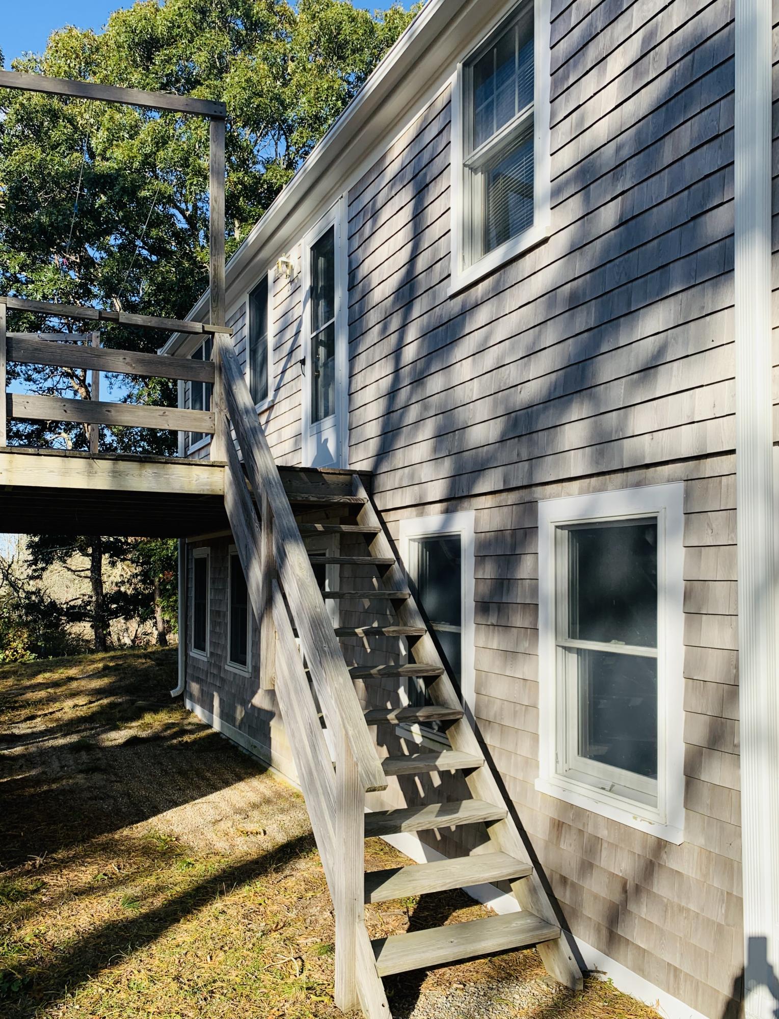 130 Peace Valley Road Wellfleet, MA 02667 - Photo 6 of 28 a picture of street view with balcony