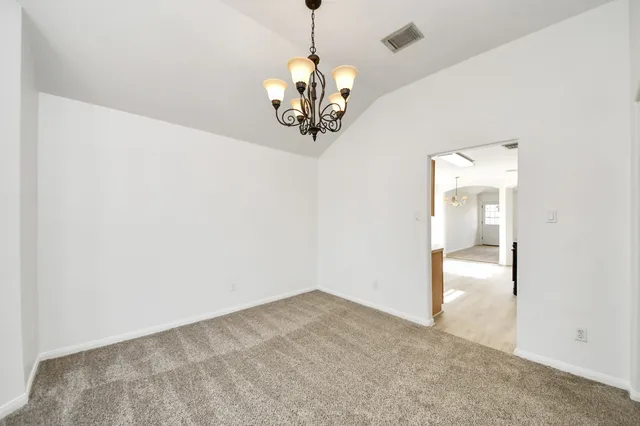 a view of a chandelier in big room and chandelier