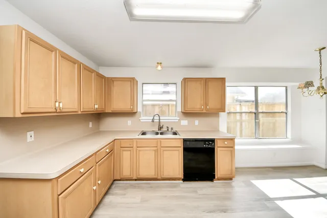 a kitchen with a sink stove and cabinets