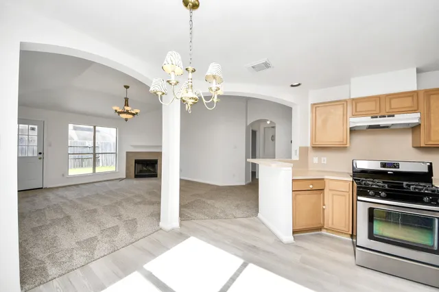a kitchen with stainless steel appliances granite countertop a stove and cabinets