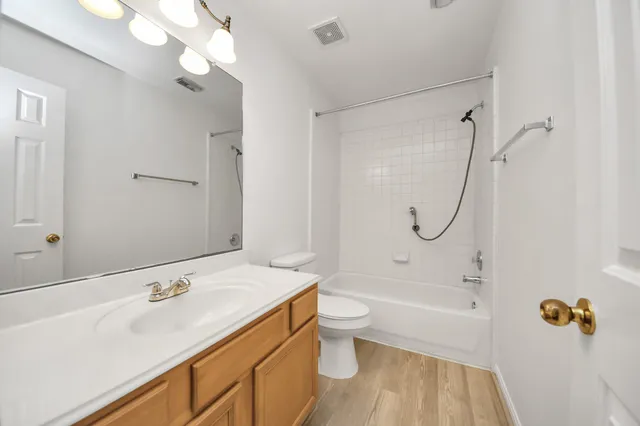 an empty room with a window and a ceiling fan