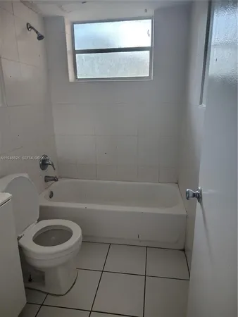 a bathroom with a toilet a bath tub and a shower