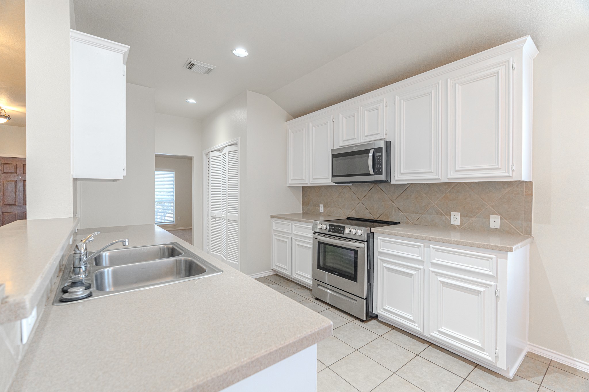 25506 Brisk Spring Court Spring, TX 77373 - Photo 16 of 45 a kitchen that has a sink and a stove top oven