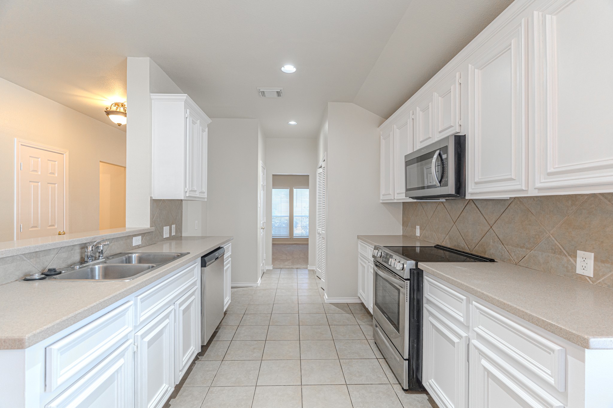 25506 Brisk Spring Court Spring, TX 77373 - Photo 17 of 45 a kitchen with a sink stove top oven and cabinets
