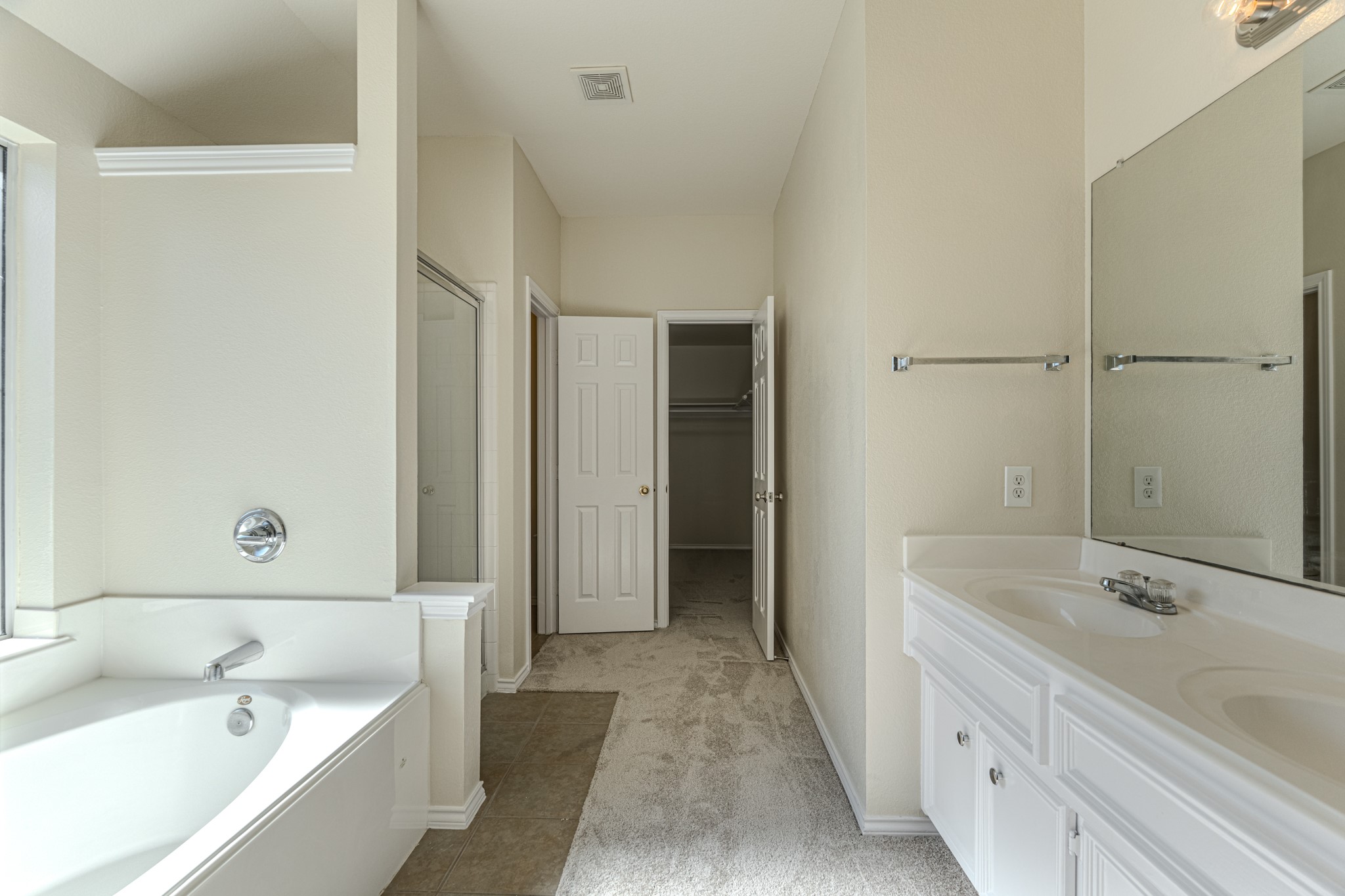 25506 Brisk Spring Court Spring, TX 77373 - Photo 26 of 45 a bathroom with a tub sink and mirror