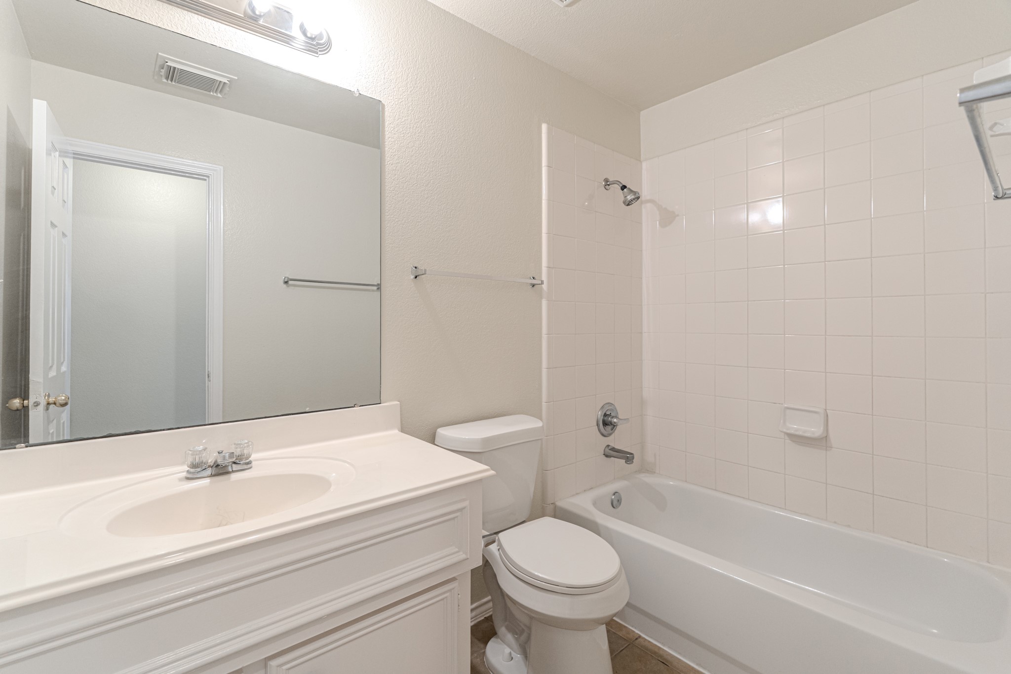 25506 Brisk Spring Court Spring, TX 77373 - Photo 32 of 45 a bathroom with a bathtub shower sink vanity mirror and toilet