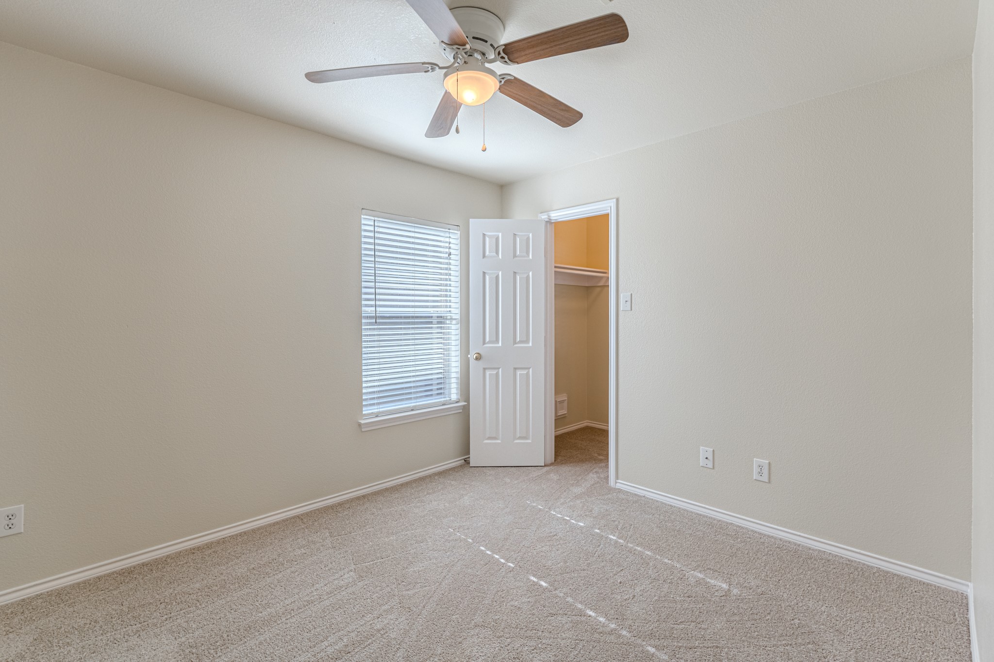 25506 Brisk Spring Court Spring, TX 77373 - Photo 33 of 45 an empty room with closet and a chandelier fan