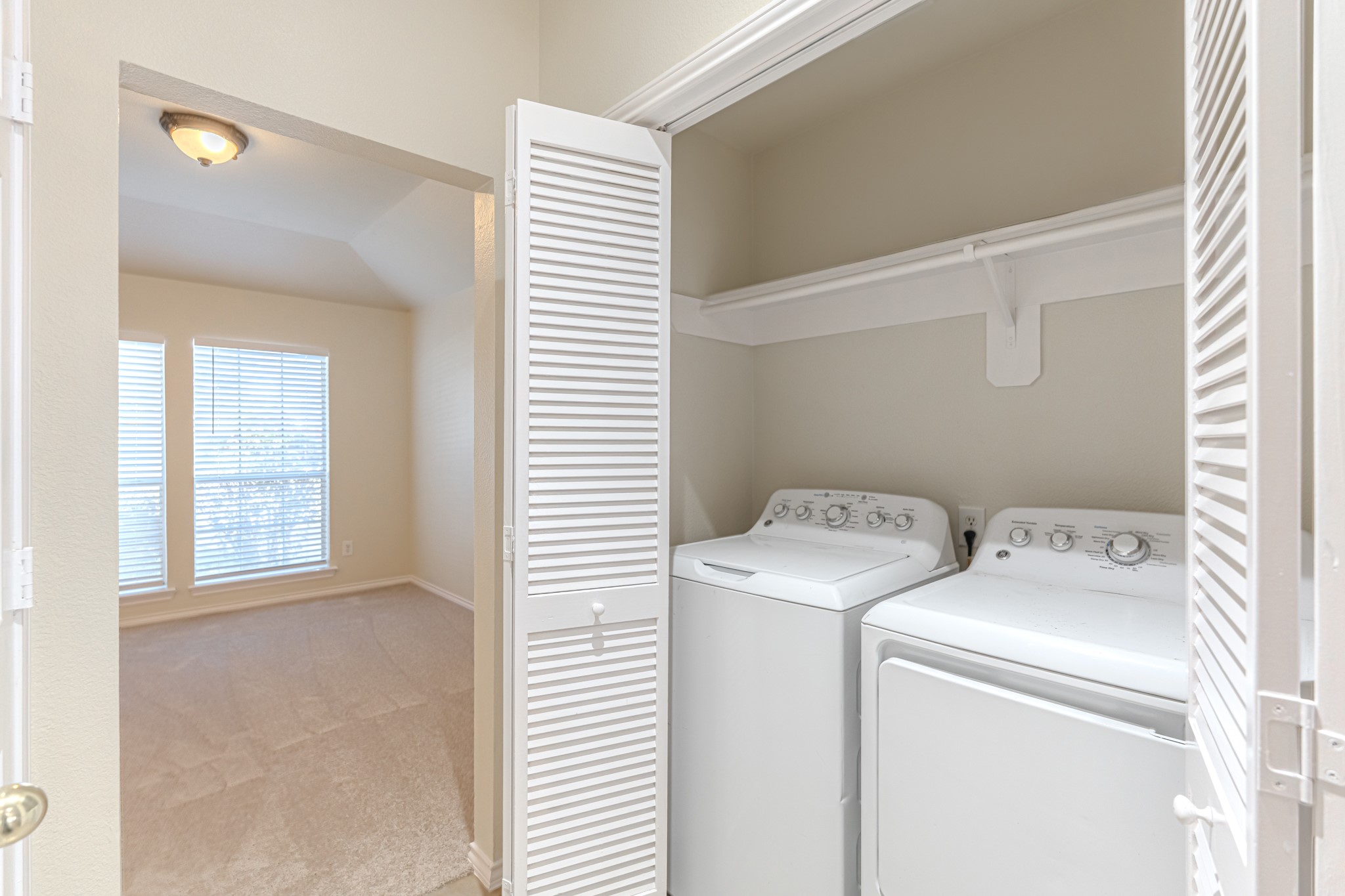 25506 Brisk Spring Court Spring, TX 77373 - Photo 35 of 45 a view of storage and utility room with washer and dryer