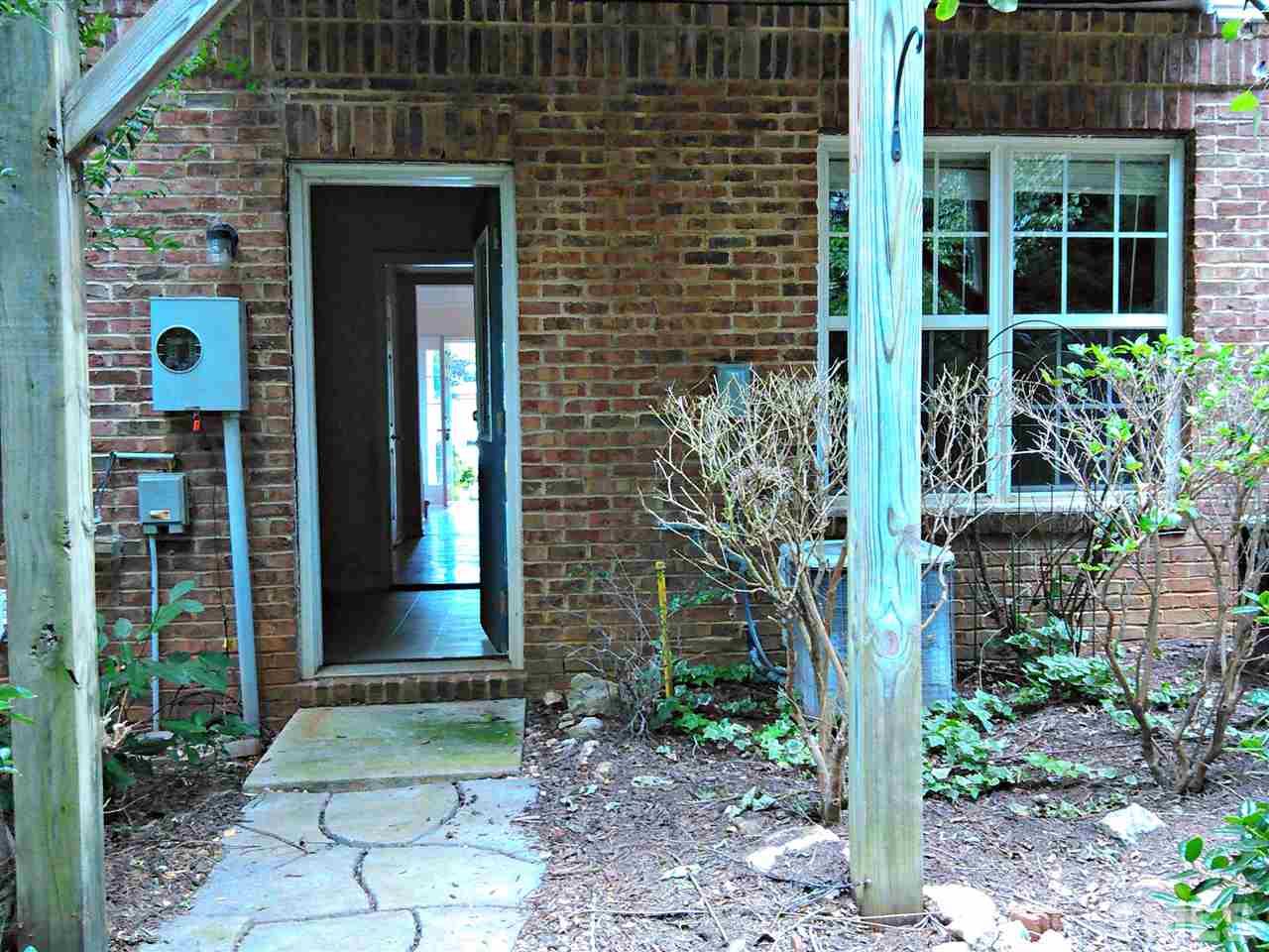 7244 Corvette Court Raleigh, NC 27613 - Photo 14 of 15 a couple of potted plants in front of door