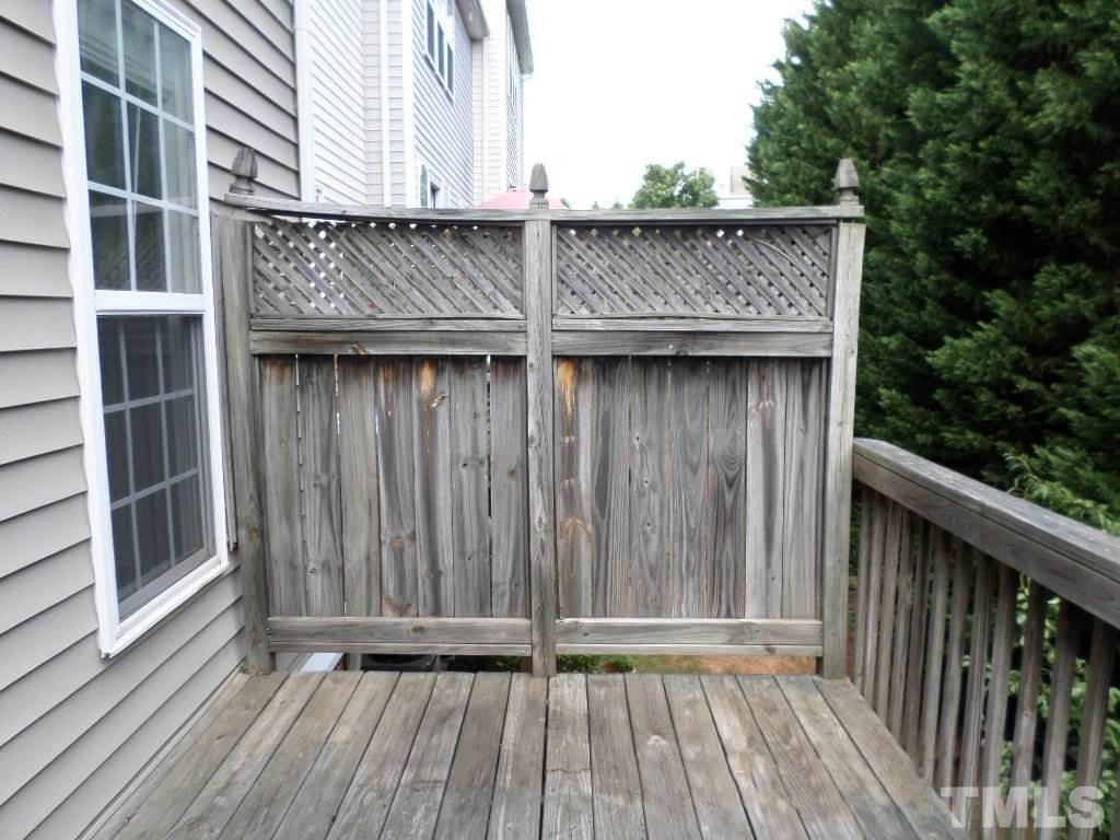7244 Corvette Court Raleigh, NC 27613 - Photo 15 of 15 a view of wooden door and brick wall