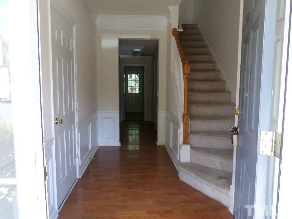7244 Corvette Court Raleigh, NC 27613 - Photo 3 of 15 a view of a hallway with wooden floor and entryway