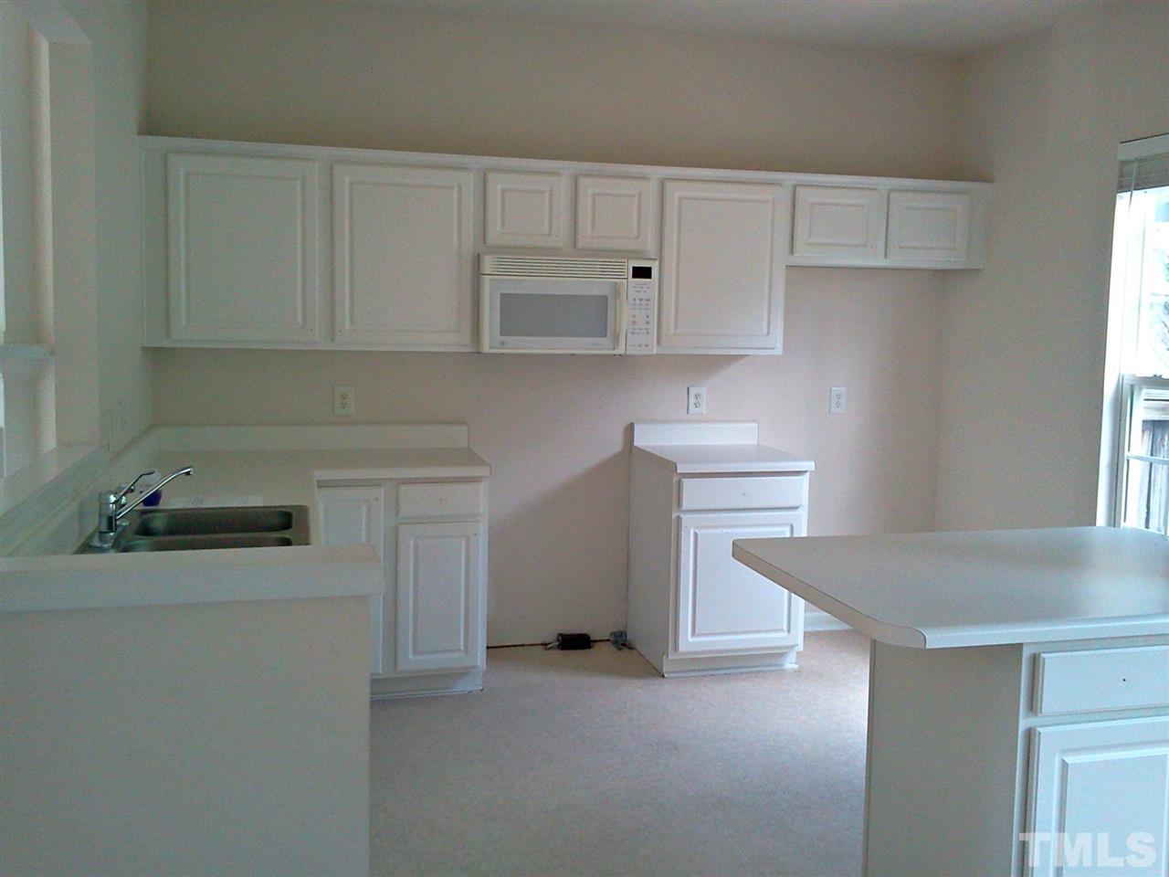 7244 Corvette Court Raleigh, NC 27613 - Photo 4 of 15 a kitchen with cabinets appliances and a counter space