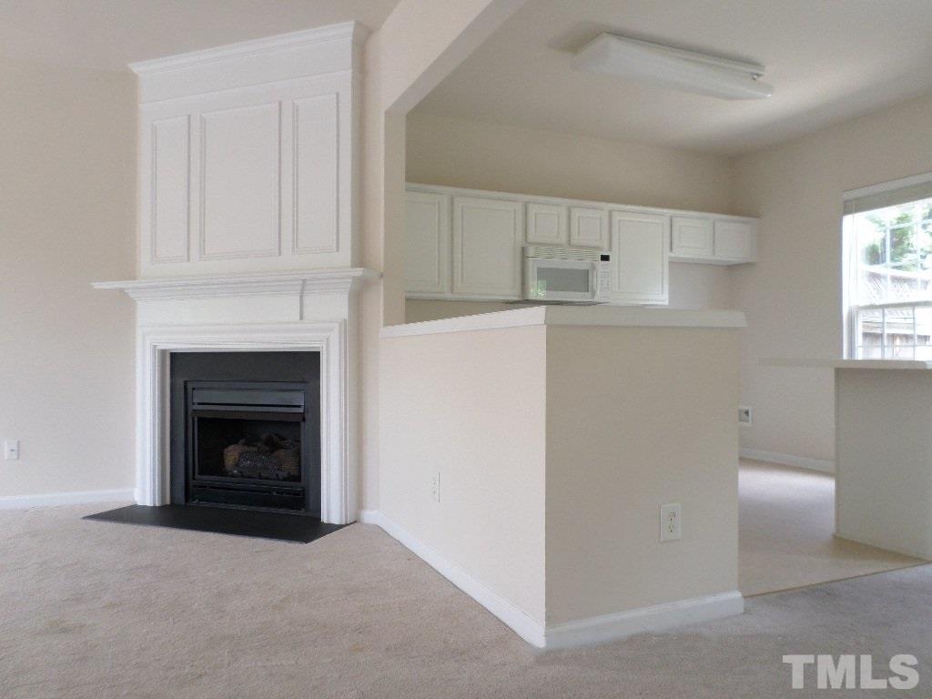 7244 Corvette Court Raleigh, NC 27613 - Photo 6 of 15 a view of a livingroom with furniture and a fireplace