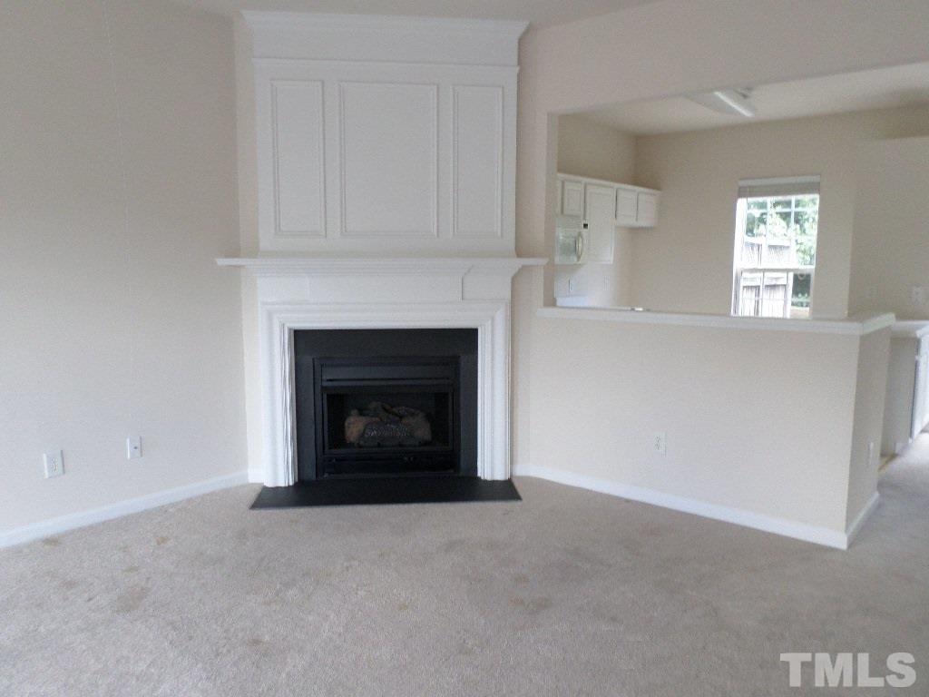 7244 Corvette Court Raleigh, NC 27613 - Photo 7 of 15 a room with a fireplace and a fireplace