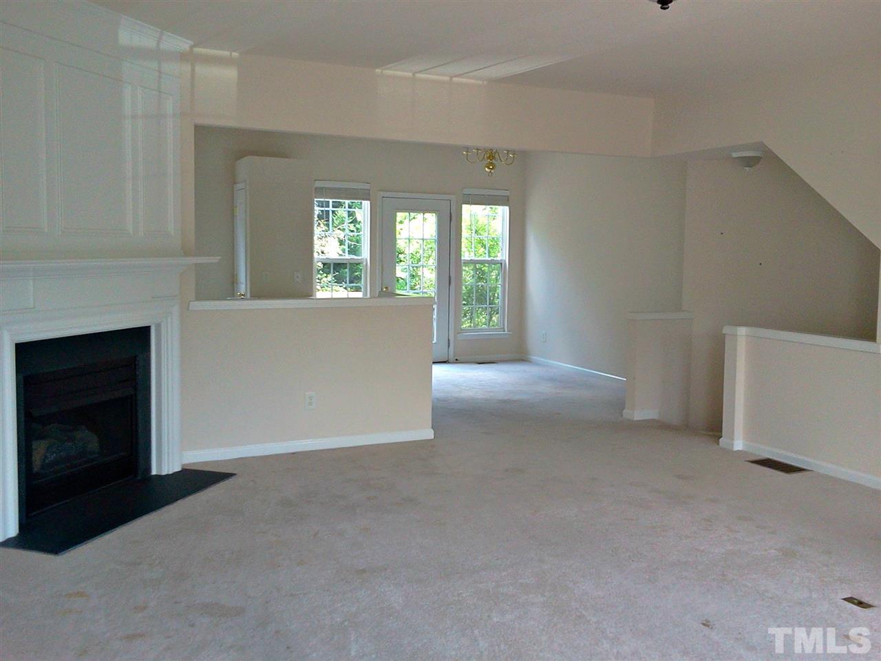 7244 Corvette Court Raleigh, NC 27613 - Photo 8 of 15 a view of an empty room with a fireplace