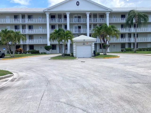 a view of a building with plants and entryway