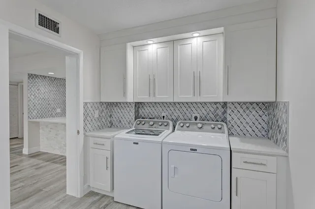 a utility room with a sink dryer and washer