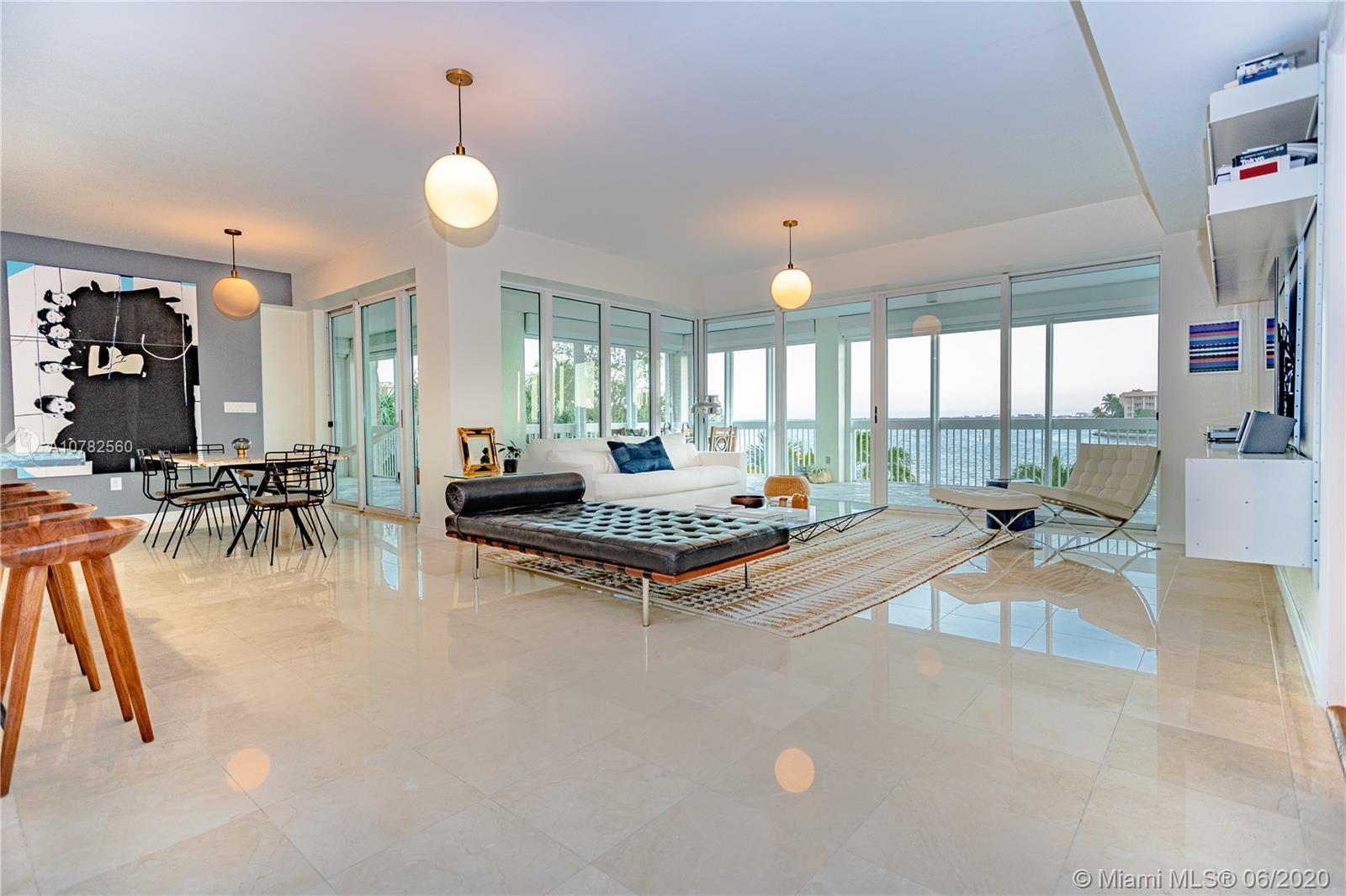 Open and spacious living room, dining room, and kitchen concept with views of Biscayne Bay from every room. Happy, Light and Bright! The 230 SQFT terrace runs the length of the entire condo with access and privacy from every room!