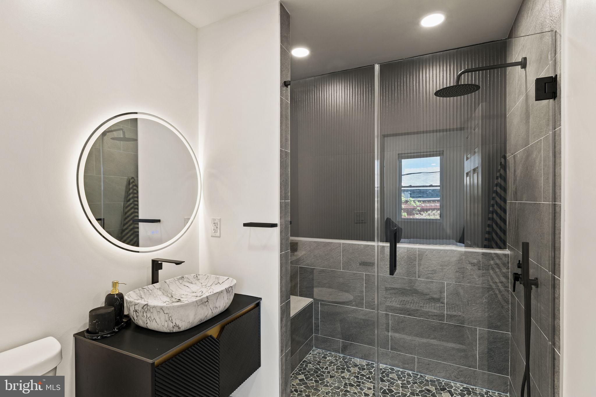 1709 North 4th Street Philadelphia, PA 19122 - Photo 25 of 50 a bathroom with a granite countertop sink a toilet and a mirror