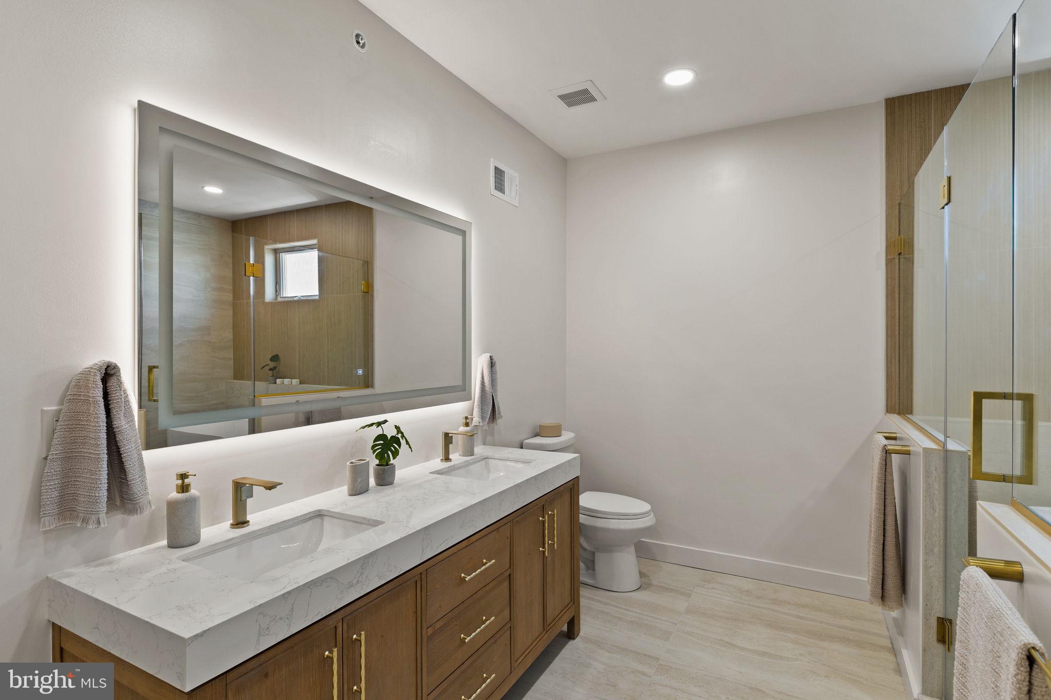 1709 North 4th Street Philadelphia, PA 19122 - Photo 34 of 50 a bathroom with a granite countertop sink a toilet and a mirror