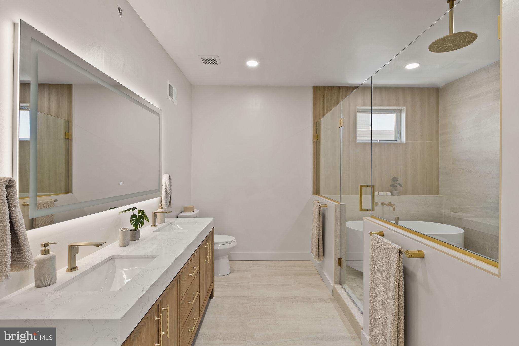 1709 North 4th Street Philadelphia, PA 19122 - Photo 35 of 50 a bathroom with a double vanity sink a mirror and a bathtub