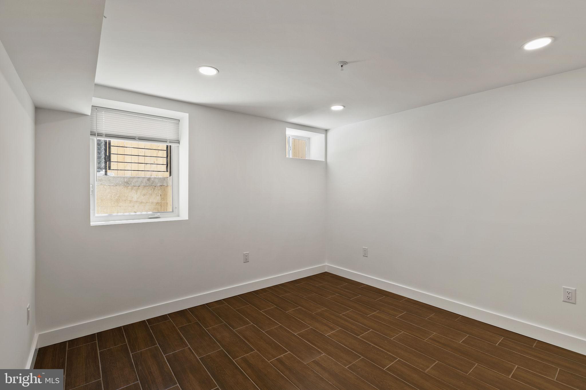 1709 North 4th Street Philadelphia, PA 19122 - Photo 48 of 50 an empty room with wooden floor and windows